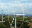 Aerial view of windmills with digitally generated holographic display tech data visualization. Wind power turbines generating clean renewable energy for sustainable development in a green ecologic way