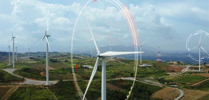 Aerial view of windmills with digitally generated holographic display tech data visualization. Wind power turbines generating clean renewable energy for sustainable development in a green ecologic way