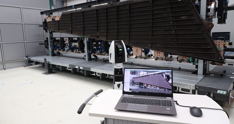 A laptop computer is connected to a leica absolute tracker ats80 measuring a large plastic object