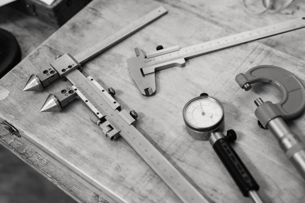 Black and white image of metrology handtools on a desk