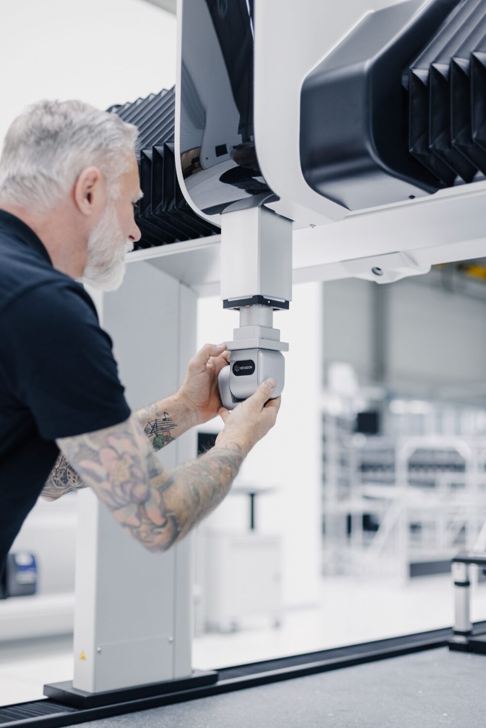 Metrologist adjusting the sensor of a CMM